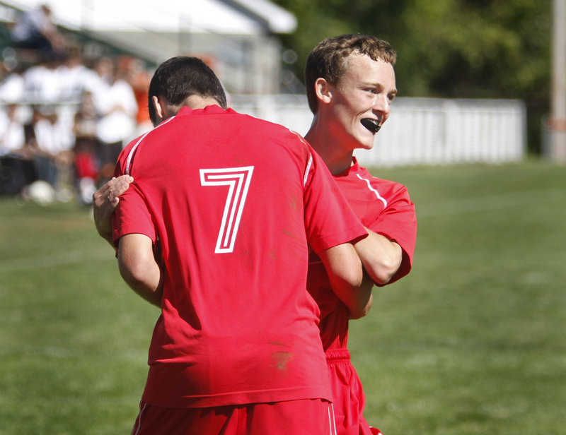Will Bushey, right, of South Portland celebrates with Nemanja Kaurin in the second half after Kaurin scored the third goal of the game for the Red Riots at Biddeford.