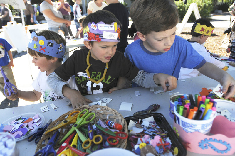 Cooper Jacobs, 3, of Freeport, Kaiden Jacobs, 5, of Freeport, and Luke Vazdauskas, 5, of Brunswick make the most of the festival by creating their own artwork.