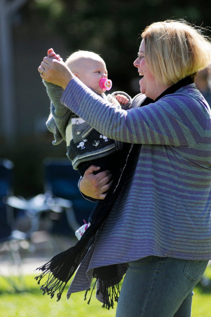 Laura Perkins of Warren dances with her 11-month-old daughter Farren on Saturday during Freeport’s 12th annual Fall in the Village Art & Music Festival.