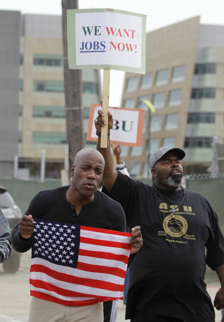 Alex Prince, who is unemployed, holds a sign demanding work as Mike Jones, also jobless, holds an American flag during a rally by workers outside a construction zone in San Francisco last week. The high jobless rate has overshadowed many of Congress’ accomplishments.
