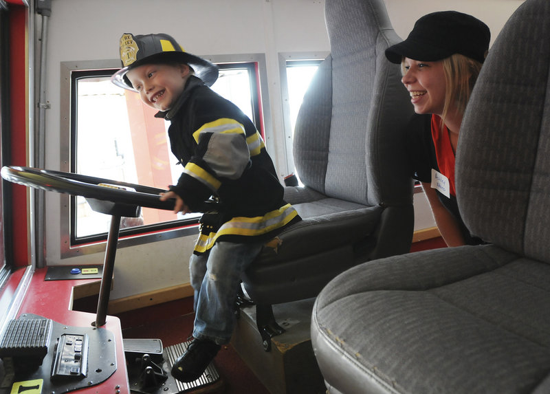 Braiden Edens, 3, of Lisbon plays in the fire truck as his mother Ashley Edens looks on during the Neonatal Intensive Care Unit Reunion of Maine Medical Center, held at the Children’s Museum and Theatre of Maine in Portland on Sunday.