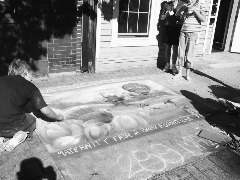 Amy Cote puts the finishing touches on a chalk creation during last year's Chalk on the Walk event in Biddeford.