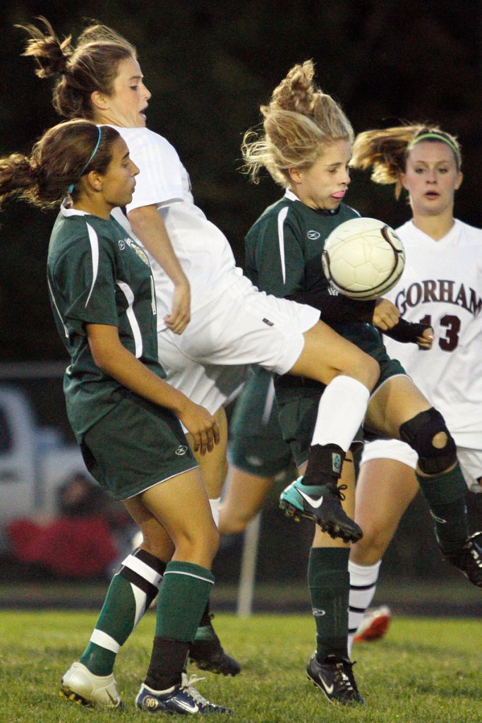 Kiersten Turner of Gorham attempts to control the ball Tuesday night while sandwiched by Allison Bonner, left, and Gabrielle Townsend of McAuley during Gorham's 2-0 victory at home.