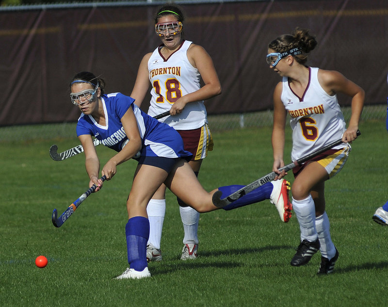 Jenn Davis of Kennebunk drives the ball ahead of Thornton Academy defenders Morgan Dube, right, and Katie Campisi during their SMAA field hockey game Wednesday at Saco. Kennebunk improved to 4-1-1 and Thornton fell to 4-2-1 as the Rams won, 3-0.