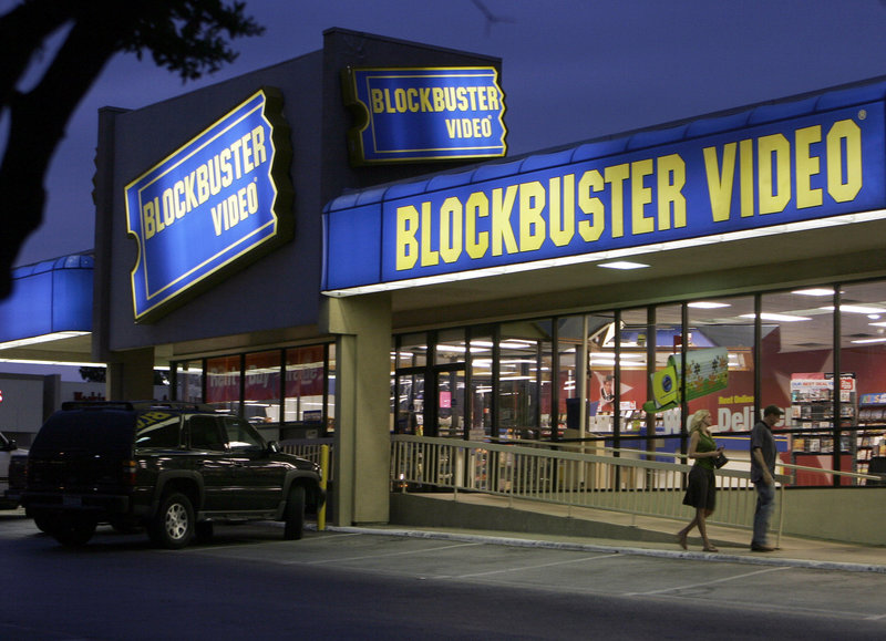 Customers enter a Blockbuster video store in Dallas in 2006. For the company to survive, its new owners will have to come up with an antidote to the dual threats posed by Netflix and video vending machine operator Redbox.