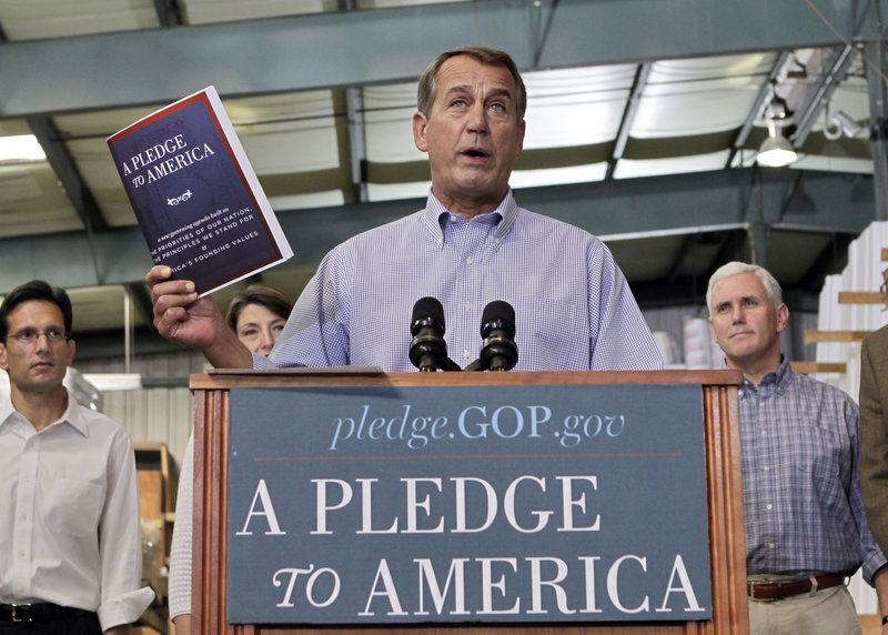 House Minority Leader John Boehner of Ohio holds up a copy of the GOP agenda, “A Pledge to America,” Thursday at a lumberyard in Sterling, Va.