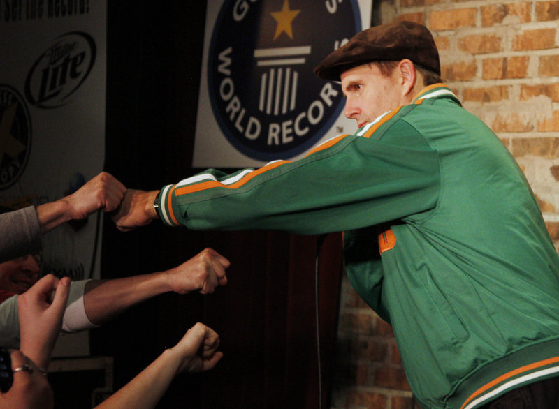 Maine comedian Bob Marley fist-bumps with the crowd after breaking the Guinness World Record for the longest standup comedy performance Thursday. The previous record of 38 hours and 6 minutes was held by Lindsay Webb of Australia.