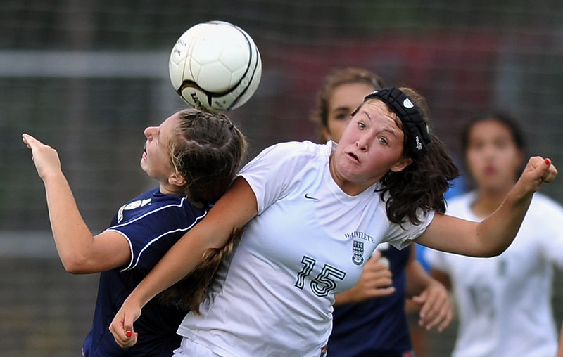 Caroline Kuliga, left, of Traip Academy and Waynflete’s Ella Millard collide going for a header Friday during a Western Maine Conference girls’ soccer game. Millard had two goals and an assist in the Flyers’ 5-0 victory.