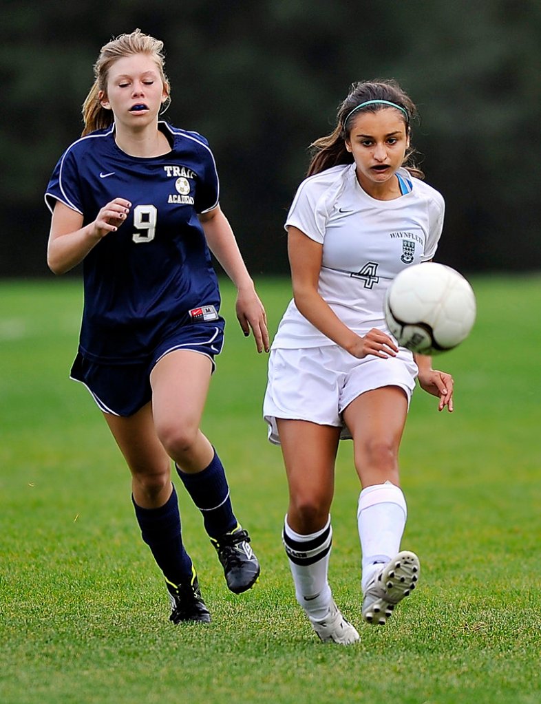 Morgane Gaudissart, left, of Traip Academy and Elena Britos of Waynflete try to catch up with a loose ball. Waynflete improved to 3-2 with the shutout.