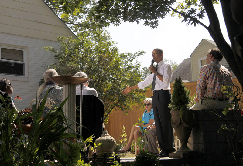President Obama, accompanied by Health and Human Services Secretary Kathleen Sebelius, center, speaks at a private residence in Falls Church, Va., this month.