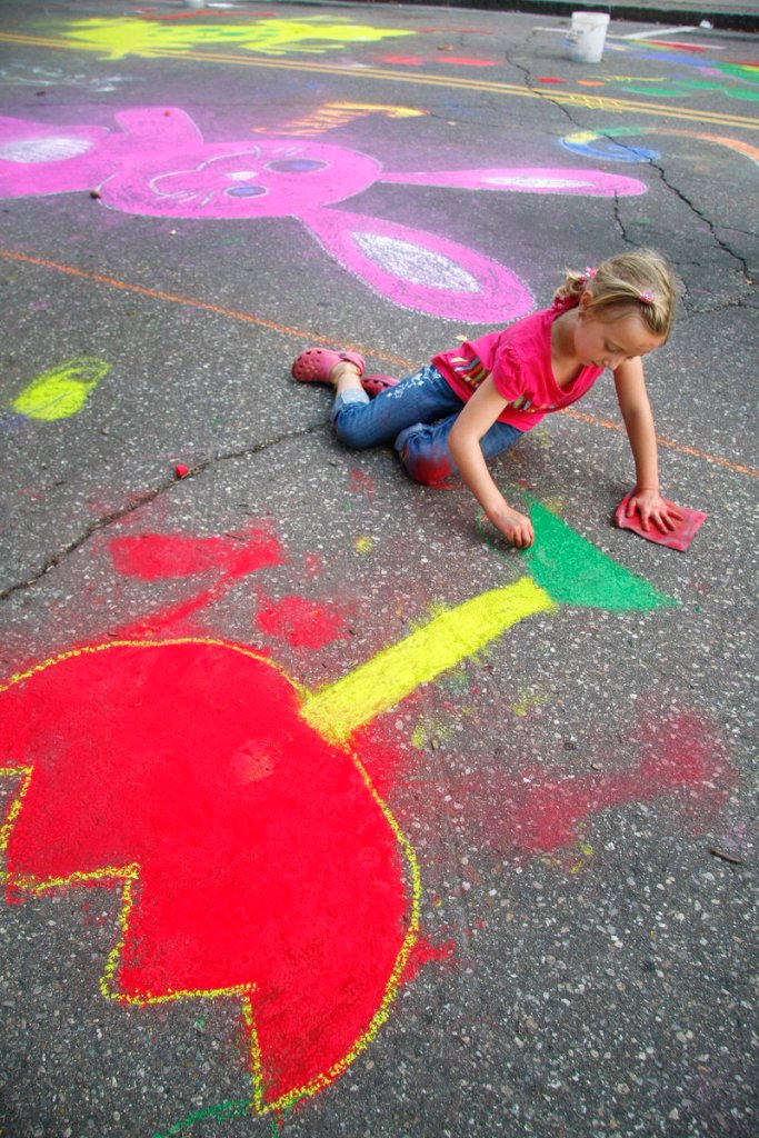 Madison Paquette, 7, adds a flower to the community mural on Adams Street during Saturday s Chalk on the Walk sponsored by Heart of Biddeford.