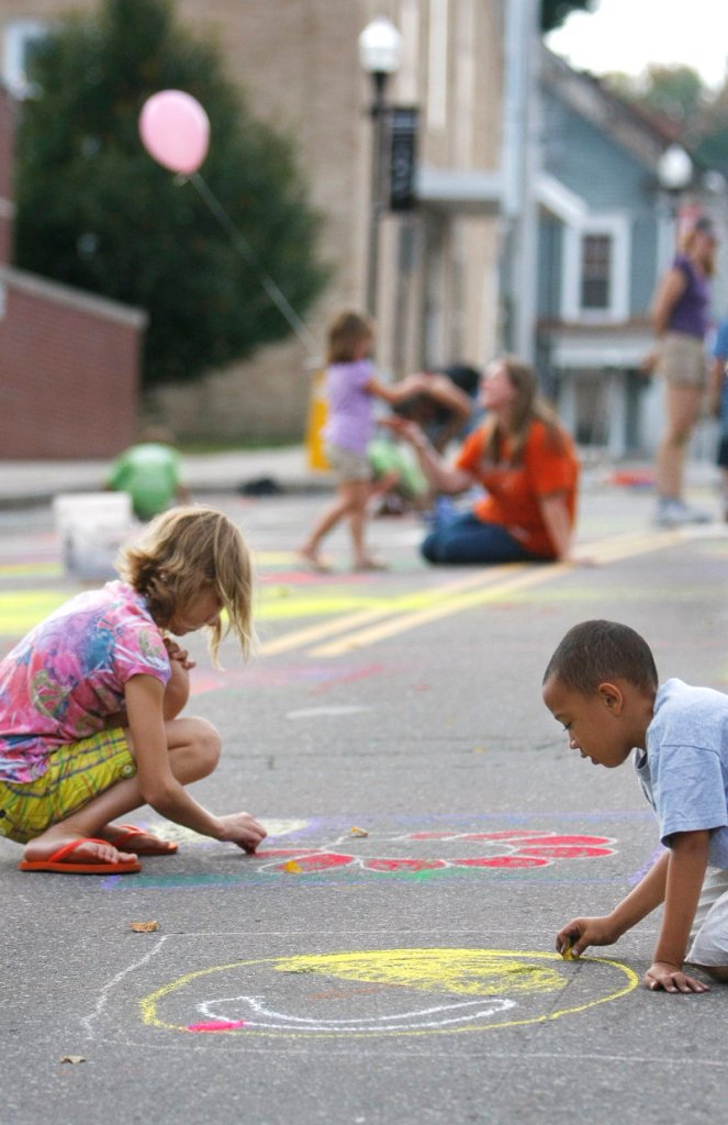 Taja Foster, 10, left, and Derek Pascal, 6, are immersed in their art on Adams Street Saturday, during the community mural project sponsored by the Heart of Biddeford organization.