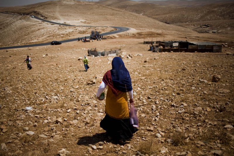 Settlers walk toward the West Bank town of Jericho, through the Jordan valley, last month. Many religious settlers believe that all of the land promised to Jews in the Bible, including what is now the West Bank, belongs to them.
