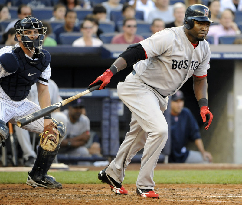 David Ortiz follows through on an RBI single as Yankees catcher Francisco Cervelli looks on during the third inning of Boston’s 7-3 win Saturday at Yankee Stadium in New York.