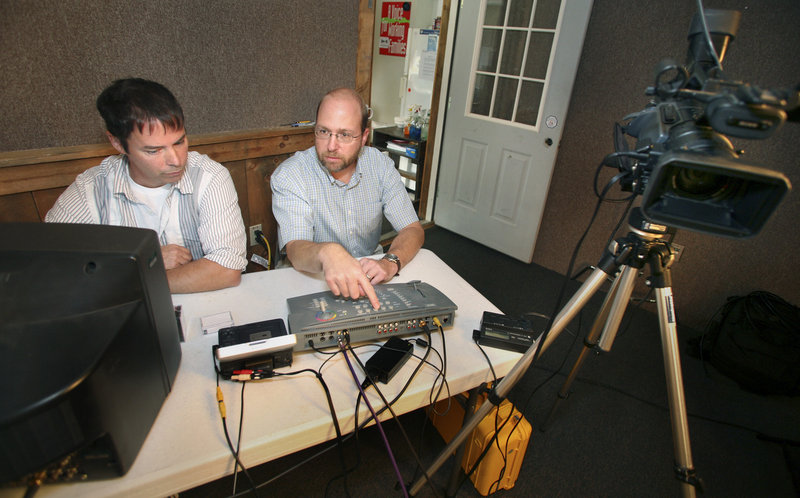 Reporter Ray Routhier, right, changes camera views with station manager Patrick Bonsant at Saco River Community Television in Hollis. The public access station serves six towns.