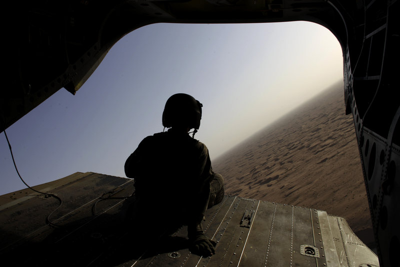 A U.S. Army Chinook helicopter crew chief sits on the tail ramp of his craft, used to transport U.S. and Afghan soldiers, in the Zhari District of Afghanistan on Sept. 11. American commanders hope to clear Taliban-held areas before President Obama makes a critical assessment of the effectiveness of the surge.