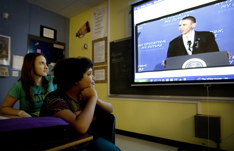 Eighth-graders Caitlin Anderson, left, 13, and Amani Alexander, 13, watch President Obama’s speech to the nation’s students earlier this month from their classroom at Fulmore Middle School in Austin, Texas. On Monday, Obama said many students are losing a lot of what they learn in school due to the length of summer vacation.