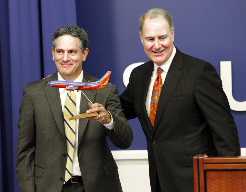 AirTran CEO Bob Fornaro, left, is seen with Southwest CEO Gary C. Kelly in Southwest’s Dallas headquarters on Monday.