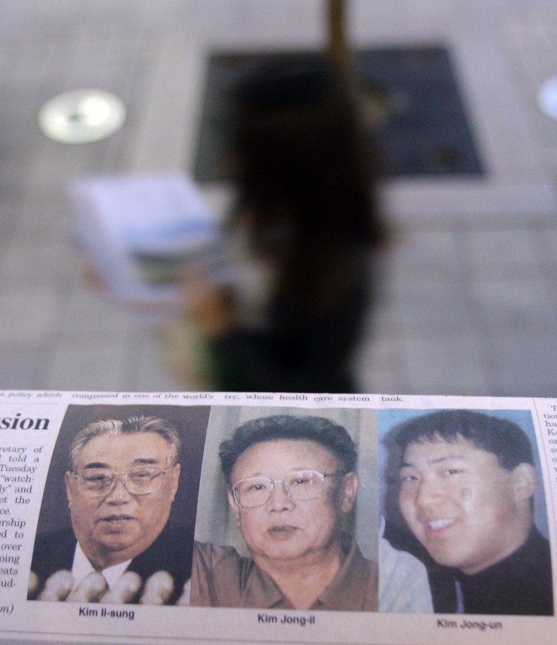 A South Korean newspaper with photos of North Korean leader Kim Jong Il, center, his late father, left, and a photo said by South Korean media to be of Kim's youngest son, Kim Jong Un, is seen on a Seoul newsstand Tuesday.