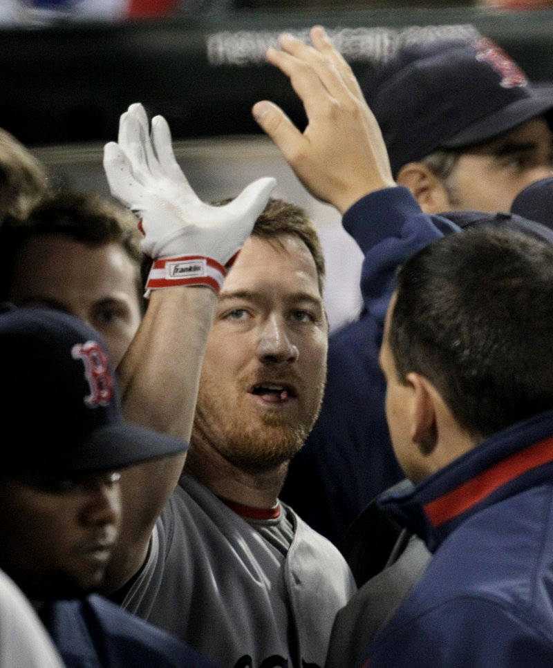 J.D. Drew of the Boston Red Sox is greeted Tuesday night after hitting a home run off Edwin Jackson of the Chicago White Sox in the third inning of Chicago’s 5-4 victory.