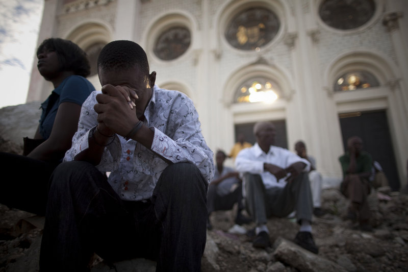 Catholics pray in the rubble of the Notre Dame cathedral during Mass in Port-au-Prince on Sunday. Haiti was devastated by a magnitude-7 earthquake on Jan. 12 that killed a government-estimated 300,000 people and left millions homeless.