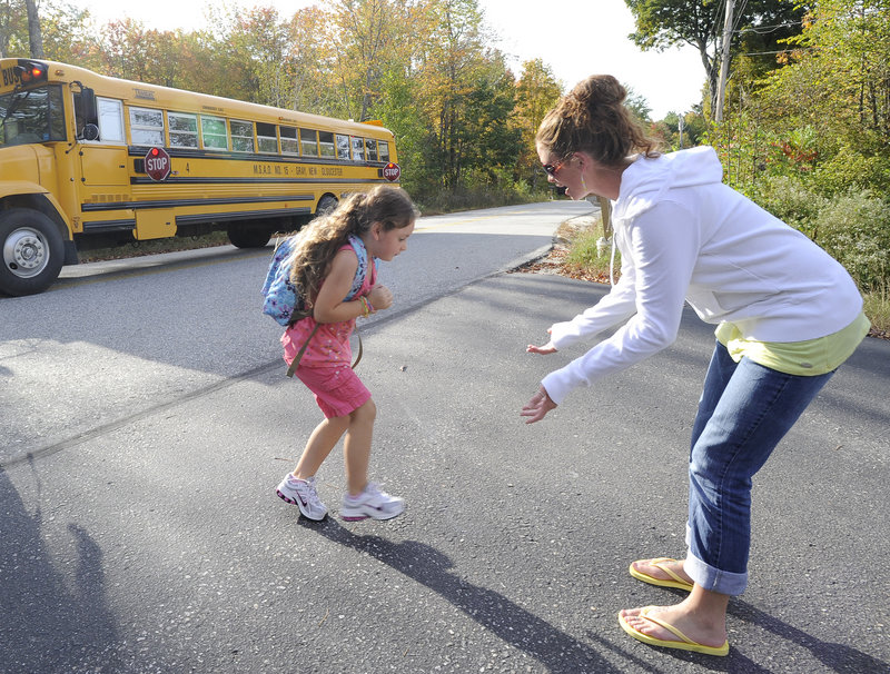 Liana Thoits meets her 5-year-old daughter Cadence Norris at her bus stop in Gray Wednesday. Thoits is angry that a bus driver dropped Cadence off by herself Monday.