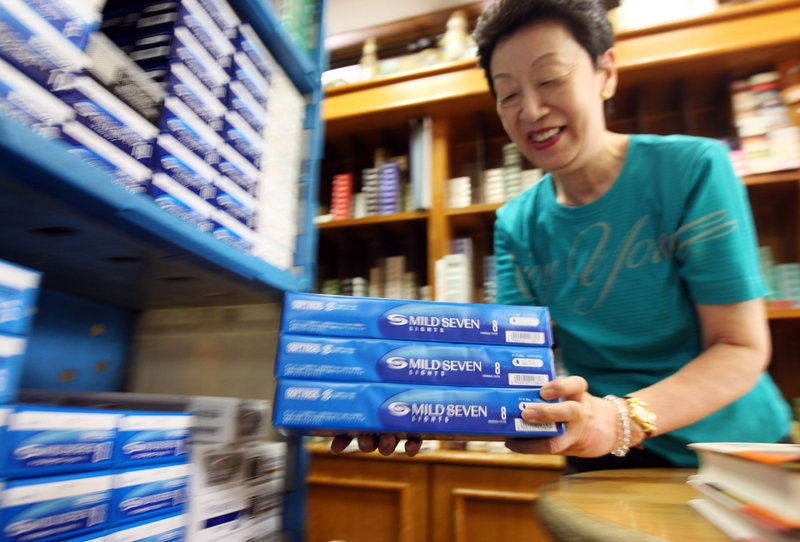 A sales clerk shelves cartons of cigarettes at a tobacco store in Tokyo, as many smokers across Japan anticipated a record 40 percent tax increase that takes effect Oct. 1. Japan is the world’s fourth-largest market for cigarettes, behind China, the U.S. and Russia.