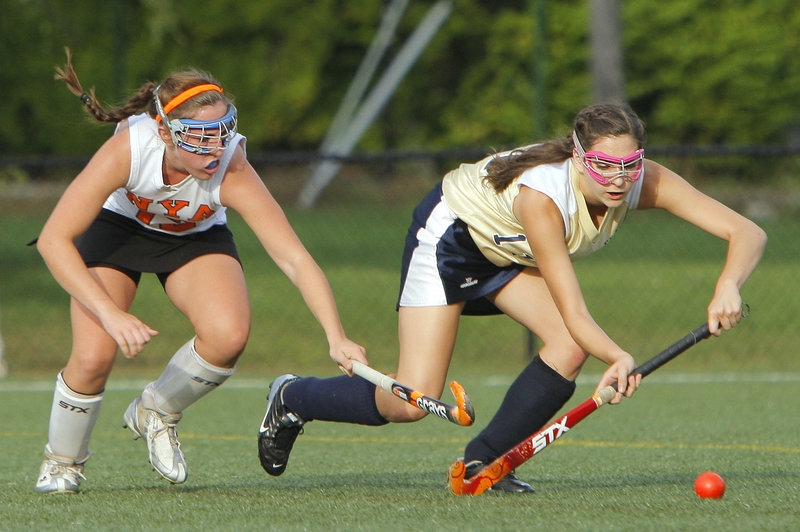 Gregory Rec/Staff Photographer Megan Fortier of North Yarmouth Academy, left, challenges Ashleigh Roberts of Traip Academy for the ball Wednesday during the first half of their Western Maine Conference field hockey game at Yarmouth. North Yarmouth Academy won, 9-1.