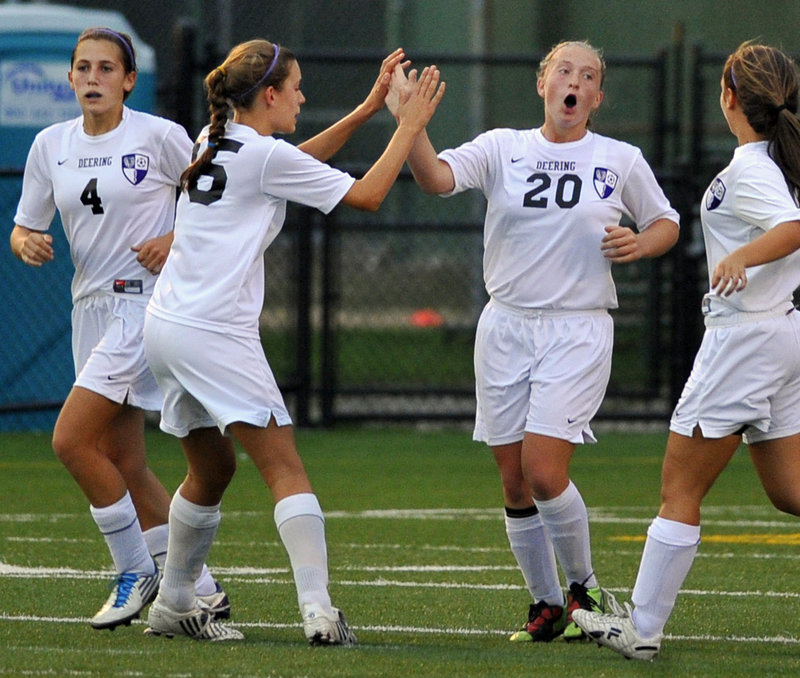 Deering freshman Alexis Elowitch, 20, receives a high-five from Georgia Hutchins after scoring the first-half goal Wednesday that gave the Rams a 1-0 victory at home against McAuley. Edie Pallozzi, left, and Tina Merrill, right, also were part of the celebration.
