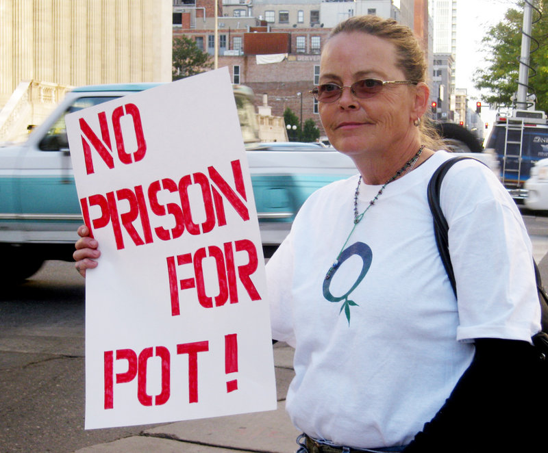 Carrie Sandoval, 56, joins marijuana activists at a protest Wednesday in Denver. Sandoval opposes a state plan to start tracking how much marijuana patients are buying and where they are getting it, saying the tracking would infringe on the privacy of people who use pot to treat disease or alleviate pain.