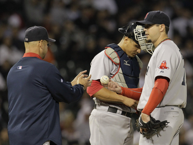 Josh Beckett of the Boston Red Sox hands the ball to Manager Terry Francona while being taken out in the seventh inning Wednesday night in a 5-2 loss to the Chicago White Sox.