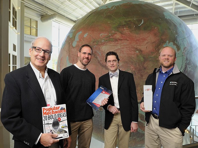 Caleb Mason, left, a DeLorme vice president, stands near the company’s world globe with other company executives: Greg Wright, hardware engineer manager; Christian Ratliff, software developer manager; and Chip Noble, product manager.