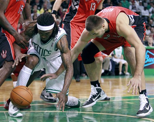 Boston Celtics' Marquis Daniels, left, battles Toronto Raptors' Linas Kleiza for the loose ball in the first quarter of a preseason NBA basketball game on Sunday in Boston. The Celtics won 91-87.
