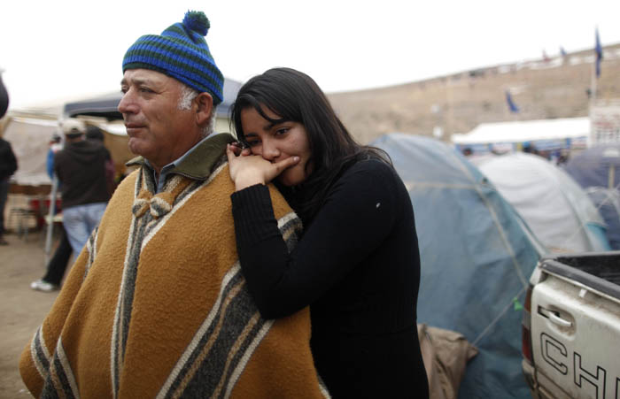 Carlos Galleguillos and Tabita Galleguillos, relatives of trapped miner Jorge Galleguillos, stand at the camp where relatives wait for news outside the San Jose mine near Copiapo, Chile, on Monday.