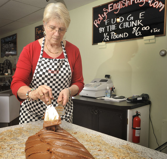 MaryBeth Munroe, owner of Roley's English Fudge and Gelato, in Kennebunkport. Monroe works a batch of fudge into a consistency for cutting into pieces at her shop recently.