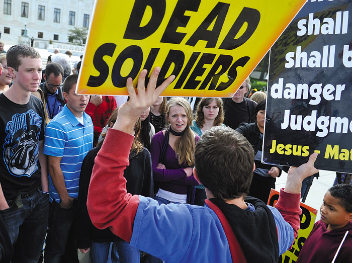 Megan Matteson, center, confronts Jacob Phelps, of Westboro Baptist Church, outside the U.S. Supreme Court Wednesday. Supreme Court justices are pondering the vexing question of whether the father of a dead Marine should win his lawsuit against a fundamentalist church group that picketed his son's funeral.