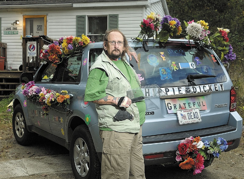Dick "Hippie Dickey" Furfey stands beside his decorated vehicle on Friday morning. Furfey, a combat wounded Vietnam veteran, holds a blade guard which was all that was left from a table saw that was recently stolen from his Windsor residence.