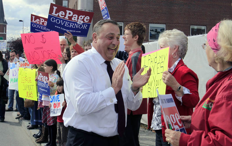 Republican gubernatorial candidate Paul LePage, center, greets supporters during a health care rally in front of Central Maine Medical Center hospital in Lewiston today. LePage said he attended the rally to draw attention to the state's debt to hospitals for payments for Medicaid services.