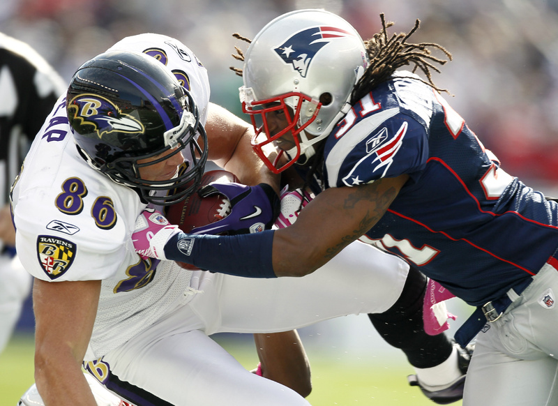 New England Patriots safety Brandon Meriweather , right, hits Baltimore Ravens tight end Todd Heap (86) during the first quarter Sunday in Foxborough, Mass. The Pats won in OT, 23-20.