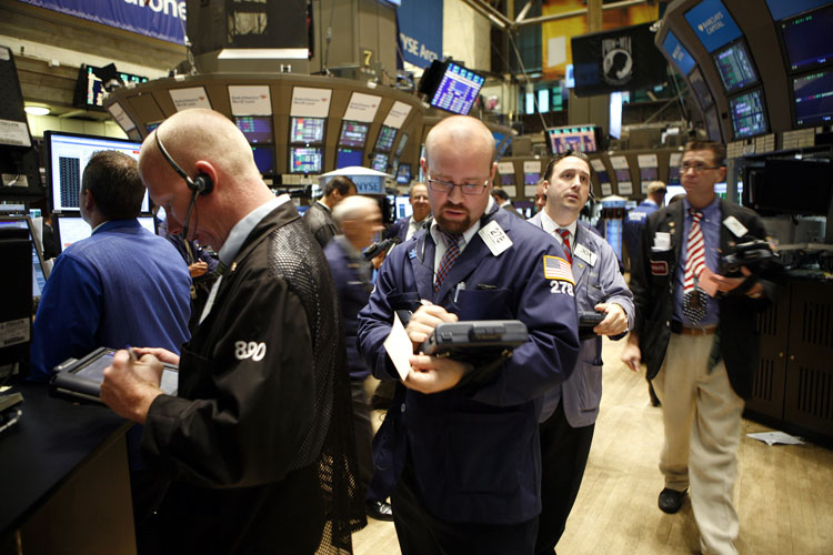 Traders and specialists work the trading floor of the New York Stock Exchange recently. On May 6, the Dow Jones had been down about 2.5 percent at 2:30 p.m., when a trader placed an enormous sell order on a futures index of the S&P's index, called the E-Mini S&P 500. The trade was automated by a computer algorithm that was trying to hedge its risk from price declines.