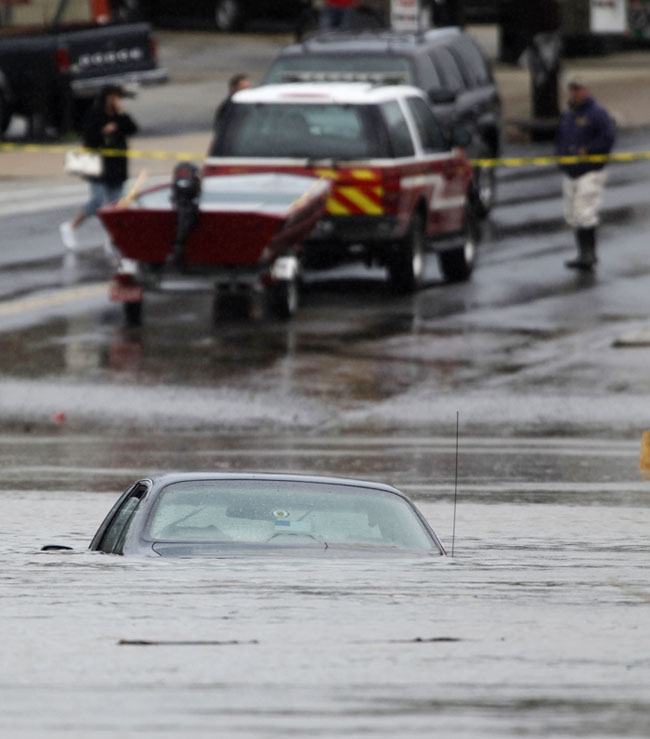 A car is submerged in floodwater in Darby, Pa., today.