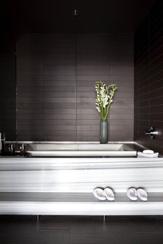 Designer Brian Flynn favors baths done in all white, black and white, or white with charcoal or black/brown.