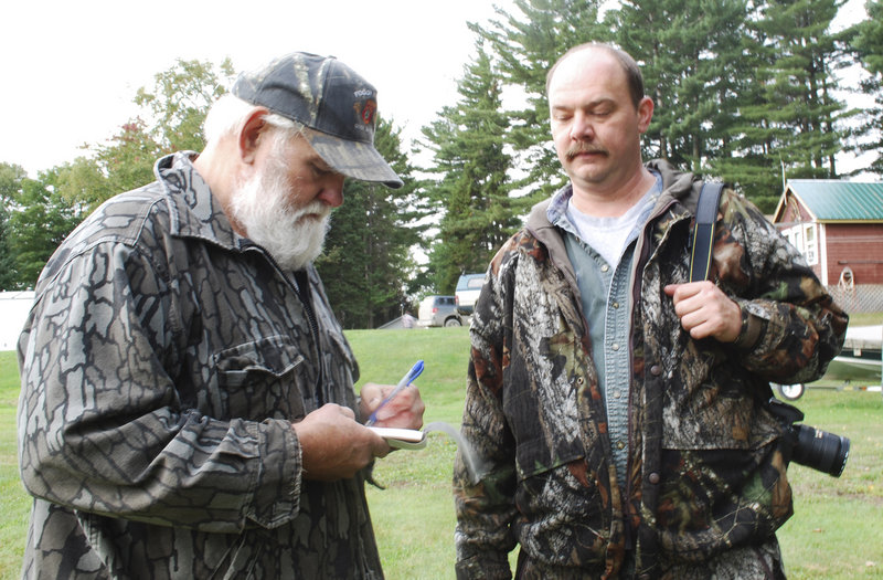 Bosowicz takes instructions from Keith Sochalsky on how the hunter from Union Township, N.J., wants the meat from the bear he shot to be butchered.