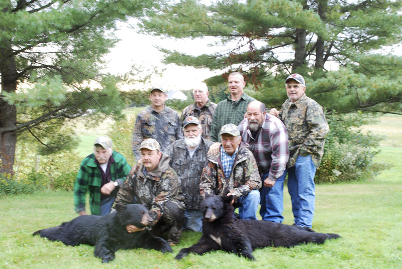 Hunters from New Jersey gather around guide Wayne Bosowicz and the two black bears shot by two members of the hunting party on Sept. 15 near Pittston Academy Grant north of Moosehead Lake.