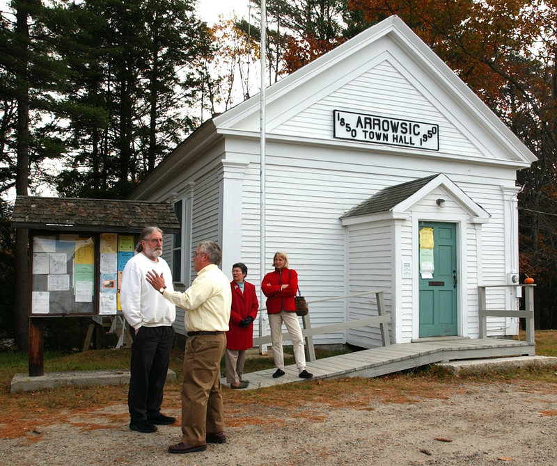Voters discuss issues outside the Arrowsic Town Hall in 2004. Small towns can be sites for experimental programs that benefit other communities or the entire state, an analyst says.