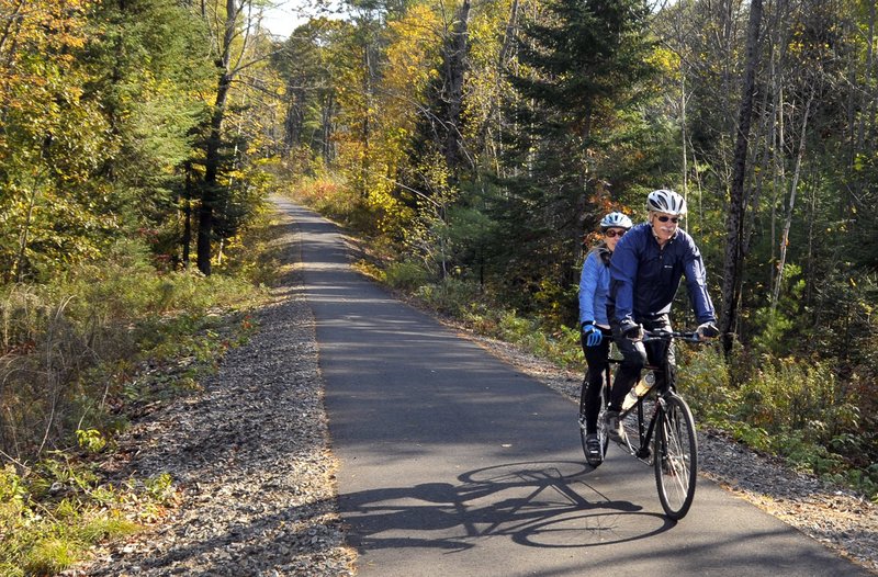 Tandem bikers ride on a connector from Gorham to the Mountain Division Trail that opened last year. Already paved trails like this are incorporated into the Sebago to the Sea Trail.
