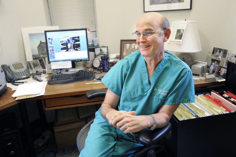 Dr. Samuel Broaddus takes a break Thursday in his South Portland office. The American College of Surgeons will recognize his international work Tuesday at a dinner in Washington, D.C.