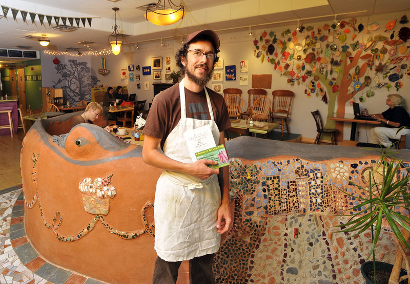 Jonah Fertig is one of three worker-owners at Local Sprouts Cafe on Congress Street in Portland, where the colorful, funky decor is one attraction and food prepared with panache is another.