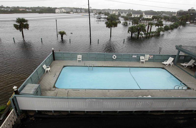 Floodwaters surround a condominium’s pool in Carolina Beach, N.C., on Thursday. The hardest rain from Thursday’s storm drenching the East Coast fell in North Carolina.