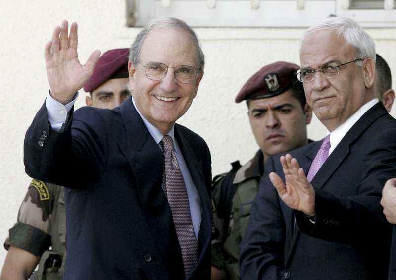 U.S. envoy George Mitchell, left, and chief Palestinian negotiator Saeb Erekat, right, wave before a meeting Thursday with Palestinian President Mahmoud Abbas in the West Bank city of Ramallah. An Abbas aide says peace talks cannot continue without an Israeli settlement freeze.